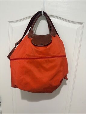Longchamp Orange Travel Bag with Brown Handles